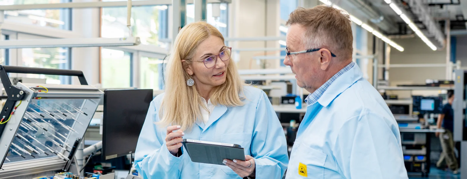 Andreea Matei and Dan Negrea from Cicor discussing medical device development in a production environment.