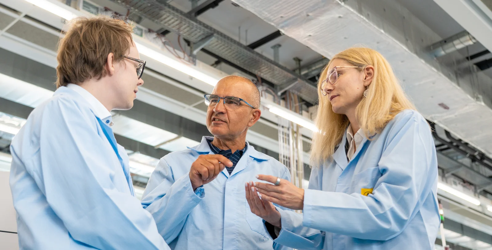 Elias Kettunen, Olivier Roy, and Andreea Matei from Cicor discussing MedTech development in a production environment.